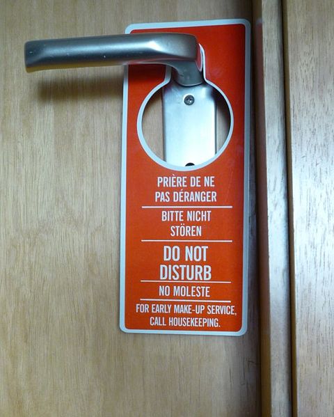 a do not disturb sign hanging on a door knob
